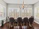 Bright dining room with hardwood floors, plantation shutters, and elegant lighting at 8470 Wallace Tatum Rd, Cumming, GA 30028