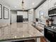 Modern kitchen featuring white cabinets, granite countertops, and stainless steel appliances at 8470 Wallace Tatum Rd, Cumming, GA 30028