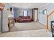 Comfortable living room with a leather sofa and a mix of carpet and tiled flooring at 8470 Wallace Tatum Rd, Cumming, GA 30028
