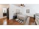 Well-lit bedroom featuring a ceiling fan, art, and an ensuite bathroom, providing comfort and convenience at 1221 Caroline Ne St # 201, Atlanta, GA 30307