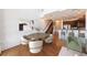 Open dining area boasts hardwood floors, modern chairs, and seamless flow into the kitchen and staircase at 1221 Caroline Ne St # 201, Atlanta, GA 30307