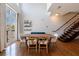 Elegant dining area with wood table, modern chairs, and hardwood floors next to metal and wood staircase at 1221 Caroline Ne St # 201, Atlanta, GA 30307