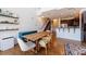 Open concept dining room featuring hardwood floors, stylish decor and adjacent kitchen with bar seating at 1221 Caroline Ne St # 201, Atlanta, GA 30307