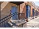Brick building entrance featuring a blue door, black railings, and decorative window details at 1221 Caroline Ne St # 201, Atlanta, GA 30307