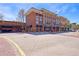 Three-story retail and parking structure with brick facade, offering street-level commercial spaces and parking access at 1221 Caroline Ne St # 201, Atlanta, GA 30307