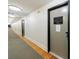 Long hallway featuring clean white walls, a carpeted floor, and doors with signs at 1221 Caroline Ne St # 201, Atlanta, GA 30307