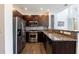 Well-equipped kitchen boasts stainless steel appliances, granite countertops, and dark wood cabinets at 1221 Caroline Ne St # 201, Atlanta, GA 30307