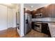 Kitchen showcasing stainless steel appliances, a mosaic backsplash, and dark wood cabinetry at 1221 Caroline Ne St # 201, Atlanta, GA 30307