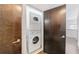 This condo features an in-unit laundry closet with a stacked washer and dryer for added convenience at 1221 Caroline Ne St # 201, Atlanta, GA 30307