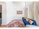 Cozy living room showcasing a blue sofa, hardwood floors, a decorative rug and flowing cream colored drapes at 1221 Caroline Ne St # 201, Atlanta, GA 30307