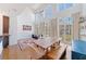 Bright living room features tall windows, hardwood floors, and a spacious dining area with custom table at 1221 Caroline Ne St # 201, Atlanta, GA 30307
