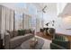 This airy living room features high ceilings, a ceiling fan, and natural light from large windows with cream-colored curtains at 1221 Caroline Ne St # 201, Atlanta, GA 30307