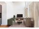 Sunlit living room with soaring ceilings, sleek furniture, and floor-to-ceiling windows with elegant drapes at 1221 Caroline Ne St # 201, Atlanta, GA 30307