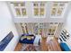 Open concept living area with hardwood floors, large windows and blue sofa at 1221 Caroline Ne St # 201, Atlanta, GA 30307