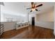 Open loft area featuring hardwood floors, half wall, and a ceiling fan at 1221 Caroline Ne St # 201, Atlanta, GA 30307