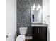 Stylish powder room featuring mosaic tile accent wall and granite vanity at 1221 Caroline Ne St # 201, Atlanta, GA 30307