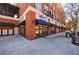 Street-level retail space with black awnings, glass storefronts, and brick facade, with mailbox for tenants at 1221 Caroline Ne St # 201, Atlanta, GA 30307