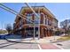 Three-story retail building with Mattress Firm, brick facade, offering street-level commercial spaces and upper floors at 1221 Caroline Ne St # 201, Atlanta, GA 30307