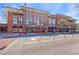 Street view of brick commercial building with awnings and outdoor seating on a sunny day at 1221 Caroline Ne St # 201, Atlanta, GA 30307