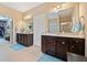 Bathroom with double sink vanity, large mirrors, and tiled floor at 300 South Village Sq, Canton, GA 30115