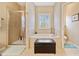 Bathroom with tiled shower, soaking tub under window, and separate toilet room at 300 South Village Sq, Canton, GA 30115