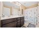 Bathroom featuring double sink vanity, large mirror, and shower-tub combo at 300 South Village Sq, Canton, GA 30115