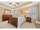 Bedroom with wood furniture, carpet floors, window with plantation shutters, and ample natural light at 300 South Village Sq, Canton, GA 30115