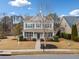 Inviting two-story home with a covered front porch and well-maintained lawn and landscape at 300 South Village Sq, Canton, GA 30115