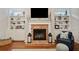 Close up of the fireplace with brick surround and built-in shelving on either side at 300 South Village Sq, Canton, GA 30115