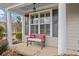 Inviting front porch with a cozy bench and red pillows, framed by white columns at 300 South Village Sq, Canton, GA 30115