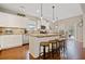 Well-lit kitchen featuring stainless steel appliances, granite countertops, and breakfast bar at 300 South Village Sq, Canton, GA 30115