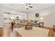 Open concept living room flowing into a modern kitchen with stainless steel appliances at 300 South Village Sq, Canton, GA 30115