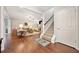 Spacious living room with hardwood floors, a cozy seating area, and a staircase leading upstairs at 300 South Village Sq, Canton, GA 30115
