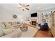 Bright living room featuring hardwood floors, fireplace, and comfortable seating at 300 South Village Sq, Canton, GA 30115