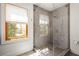 Bathroom featuring a glass enclosed shower with grey tiling, and natural light from window at 950 Clairemont Ave, Decatur, GA 30030