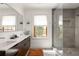 Bathroom featuring a glass enclosed shower, dark wood cabinets, and natural light from window at 950 Clairemont Ave, Decatur, GA 30030