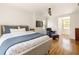 Bedroom with a ceiling fan, natural light, and seating area with a cozy armchair at 950 Clairemont Ave, Decatur, GA 30030