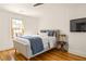 Comfortable bedroom featuring a queen bed, natural light from window, and hardwood flooring at 950 Clairemont Ave, Decatur, GA 30030
