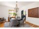 Formal dining room with stylish chairs, chandelier, and hardwood flooring at 950 Clairemont Ave, Decatur, GA 30030