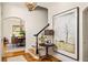 Grand foyer with hardwood floors, staircase, stylish light fixture and artwork at 950 Clairemont Ave, Decatur, GA 30030