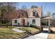 Beautiful front exterior of house with walkway, stone accents, attractive landscaping, and covered drive-through at 950 Clairemont Ave, Decatur, GA 30030
