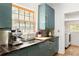 Well-lit kitchen with blue cabinets and view into a laundry room at 950 Clairemont Ave, Decatur, GA 30030