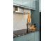 A modern kitchen featuring sleek, blue cabinetry, a stainless steel range hood and decorative cutting boards at 950 Clairemont Ave, Decatur, GA 30030