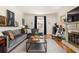 A well-lit living room with a fireplace, hardwood floors, comfortable seating and stylish decor at 950 Clairemont Ave, Decatur, GA 30030