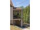 Exterior view of a screened porch featuring plants, stone foundation and covered drive-through at 950 Clairemont Ave, Decatur, GA 30030