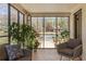 Relaxing sunroom with comfortable seating and a view of the well landscaped front yard at 950 Clairemont Ave, Decatur, GA 30030