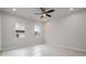 Bright, carpeted bedroom with neutral walls, ceiling fan and natural light from two windows at 58 Black Gum Ln # 47, Auburn, GA 30011