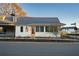 Quaint cottage showcases bright siding, metal roof, and charming street-side landscaping at 58 Black Gum Ln # 47, Auburn, GA 30011