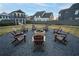 Inviting community fire pit featuring Adirondack chairs on a gravel bed, perfect for outdoor gatherings and relaxation at 58 Black Gum Ln # 47, Auburn, GA 30011