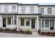 Charming townhome with white siding, black trim, and inviting front porch at 58 Black Gum Ln # 47, Auburn, GA 30011